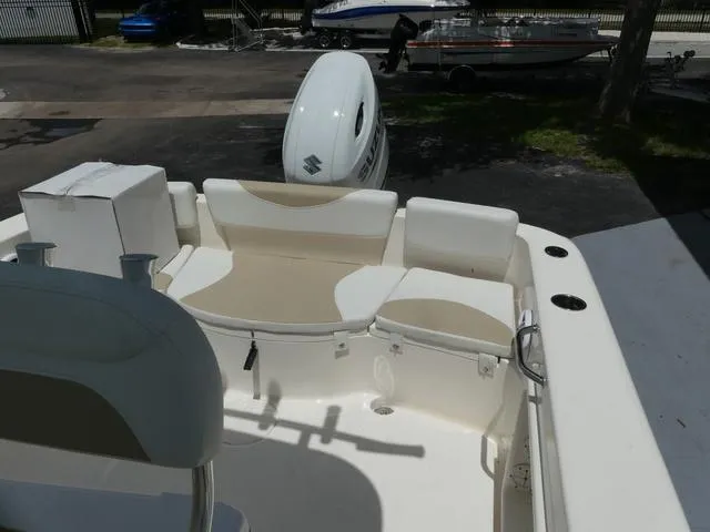 Slide: The Image of 2025 Bulls Bay 230CC boat interior with seating and Suzuki outboard motor. - 15