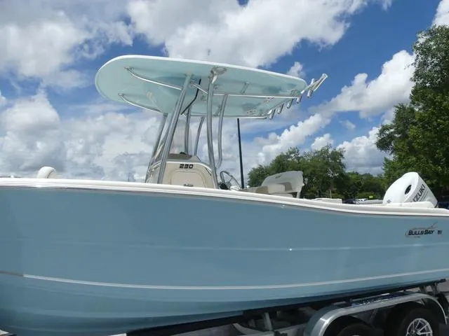 Slide: The Image of 2025 Bulls Bay 230CC center console boat on trailer under blue sky. - 3