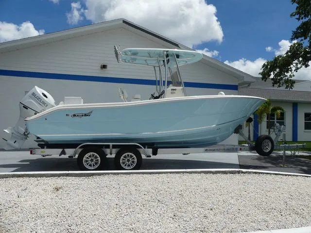 Slide: The Image of 2025 Bulls Bay 230CC boat on a trailer outside a building under a blue sky. - 7