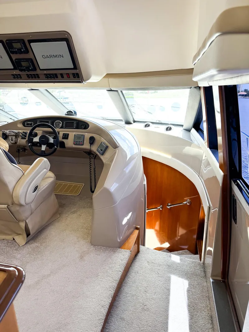 Slide: The Image of 2006 Carver 560 Voyager yacht interior with helm station and staircase. - 11