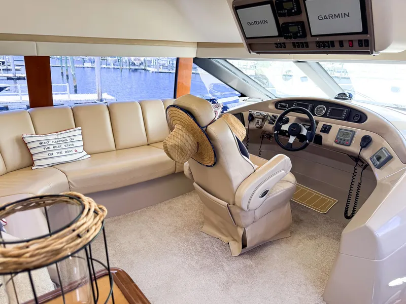 Slide: The Image of Interior of a 2006 Carver 560 Voyager yacht with beige leather seating and Garmin navigation. - 12