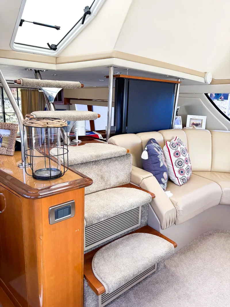 Slide: The Image of Interior of 2006 Carver 560 Voyager yacht with beige seating and decorative pillows. - 14