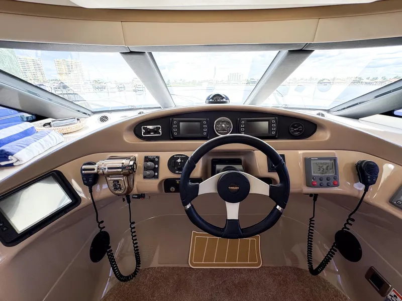 Slide: The Image of 2006 Carver 560 Voyager helm with navigation instruments and steering wheel. - 16