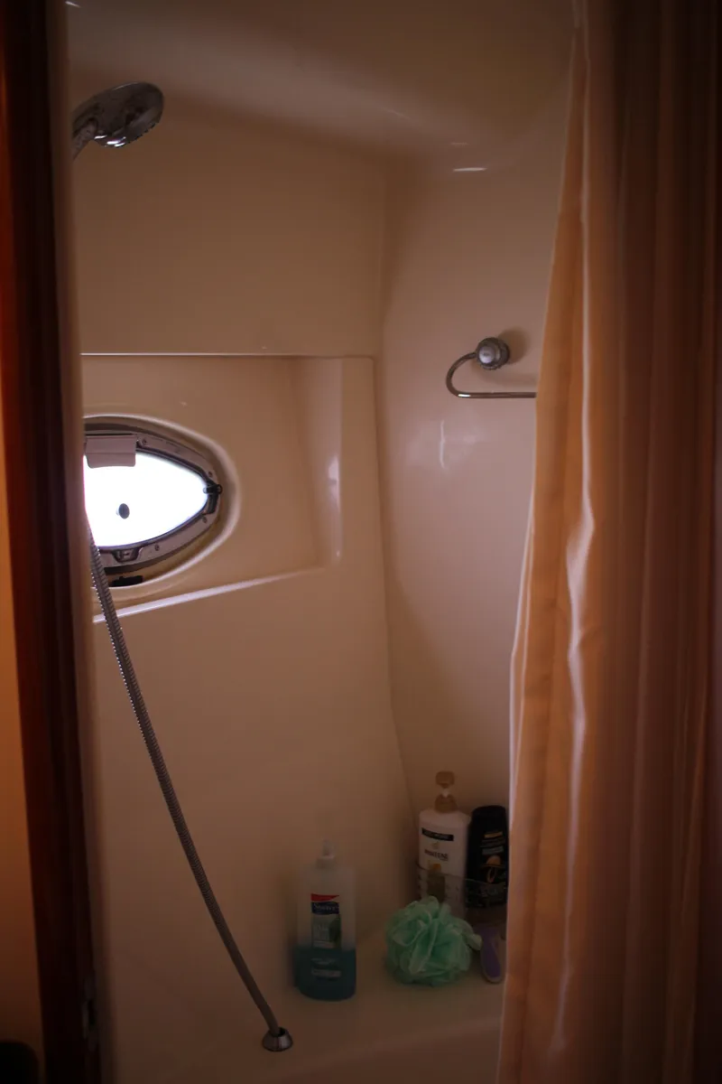 Slide: The Image of Shower area in 2006 Carver 560 Voyager yacht with porthole and toiletries. - 18