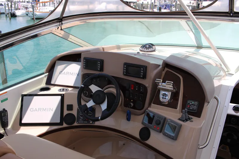 Slide: The Image of 2006 Carver 560 Voyager helm with Garmin navigation system, steering wheel, and control panels. - 29