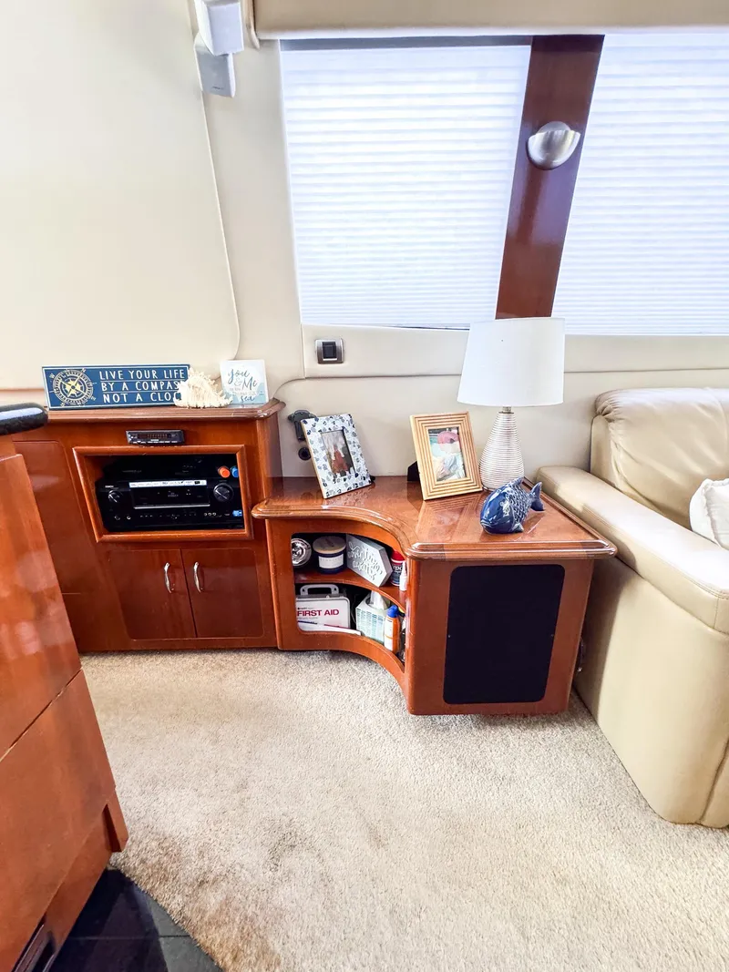 Slide: The Image of Interior of 2006 Carver 560 Voyager yacht with wooden cabinetry and cozy decor. - 4