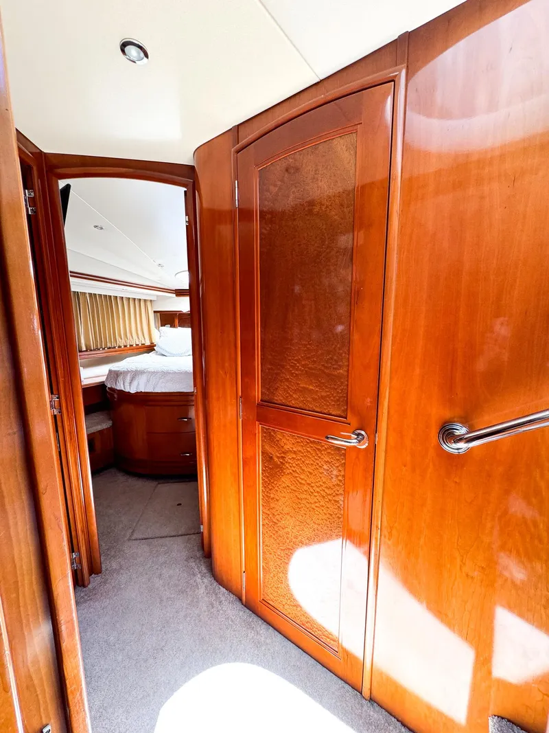 Slide: The Image of Interior of 2006 Carver 560 Voyager yacht with wooden doors and cozy bedroom. - 43