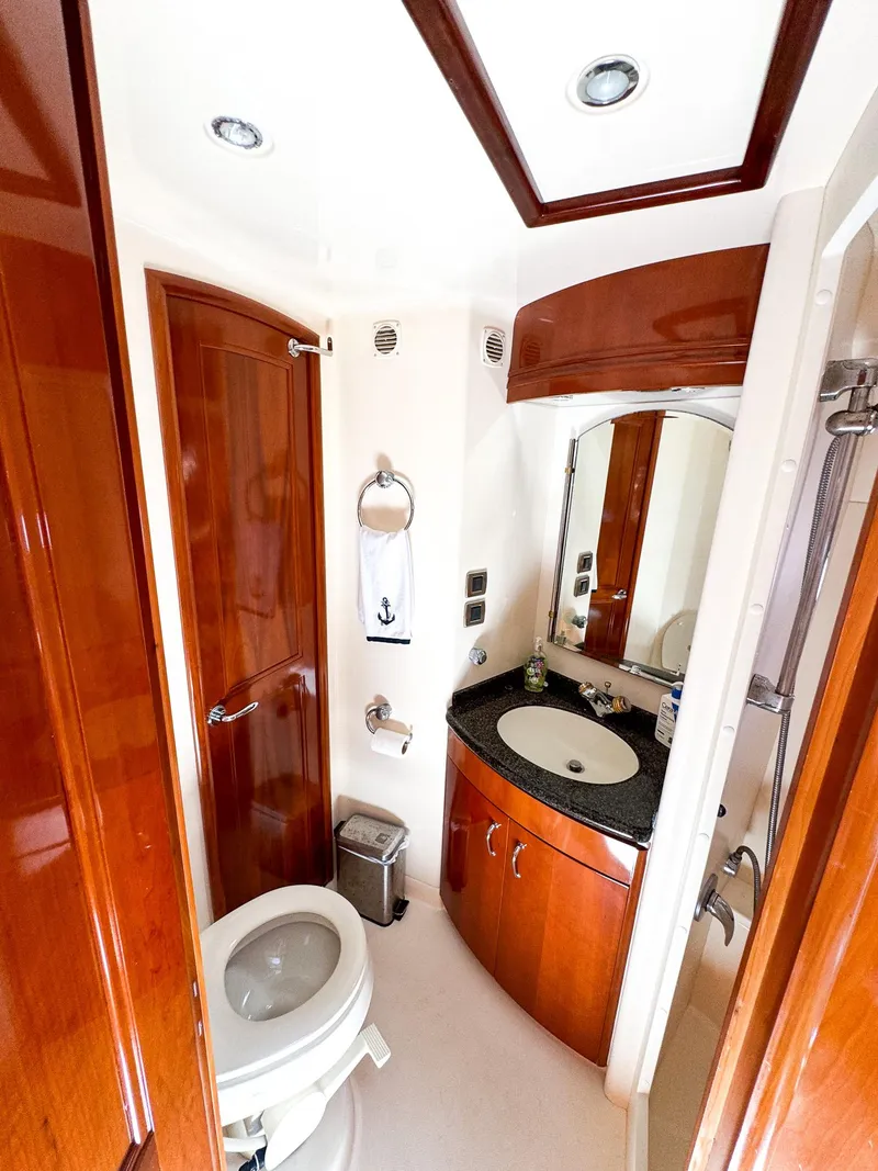 Slide: The Image of Luxurious bathroom in 2006 Carver 560 Voyager yacht with wood accents and modern fixtures. - 44