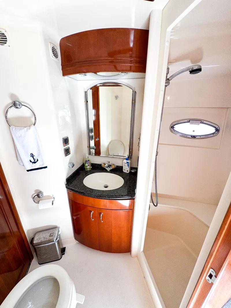 Slide: The Image of 2006 Carver 560 Voyager bathroom with sink, mirror, and shower. - 45