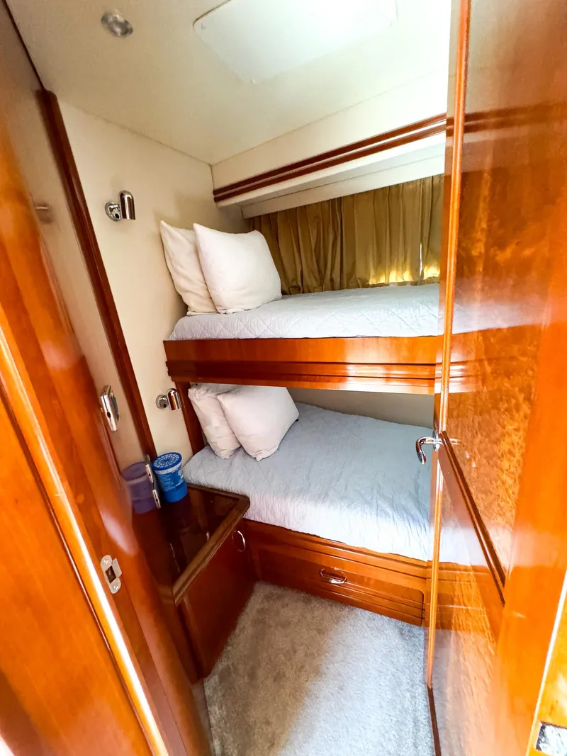 Slide: The Image of 2006 Carver 560 Voyager cabin with bunk beds and wooden interior. - 46
