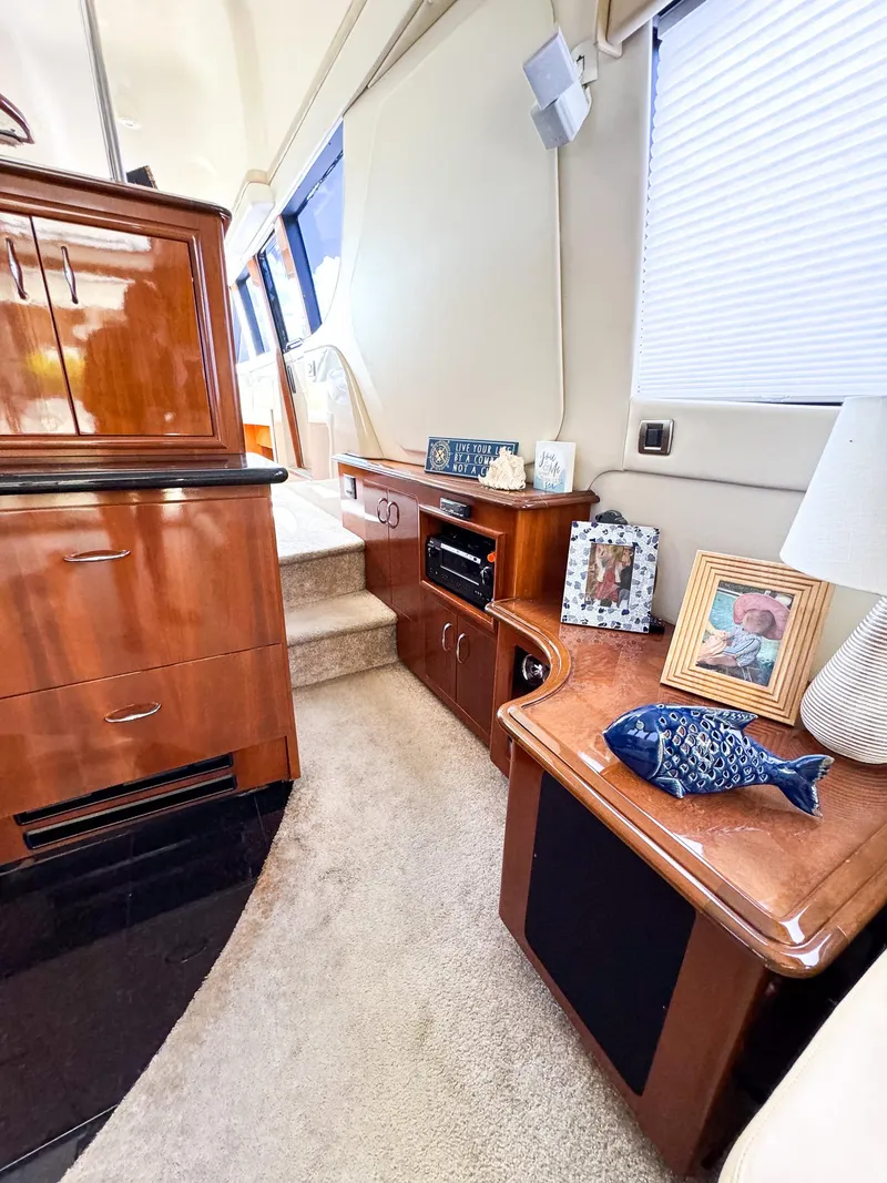 Slide: The Image of Interior of a 2006 Carver 560 Voyager yacht with wooden cabinetry and carpeted flooring. - 7