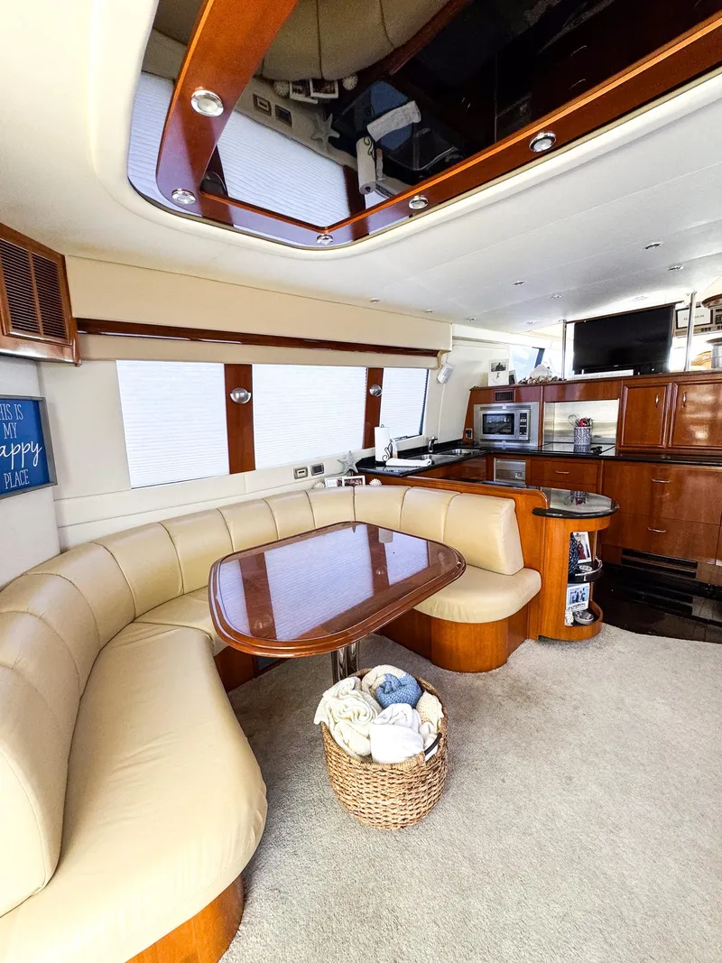 Slide: The Image of Interior of 2006 Carver 560 Voyager yacht with dining area and kitchen. - 8