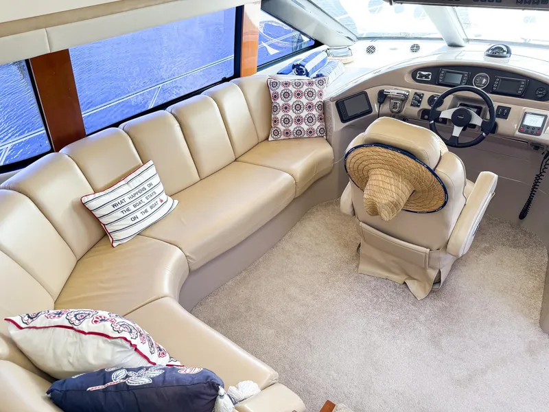 Slide: The Image of Interior of 2006 Carver 560 Voyager yacht with beige leather seating and helm. - 13