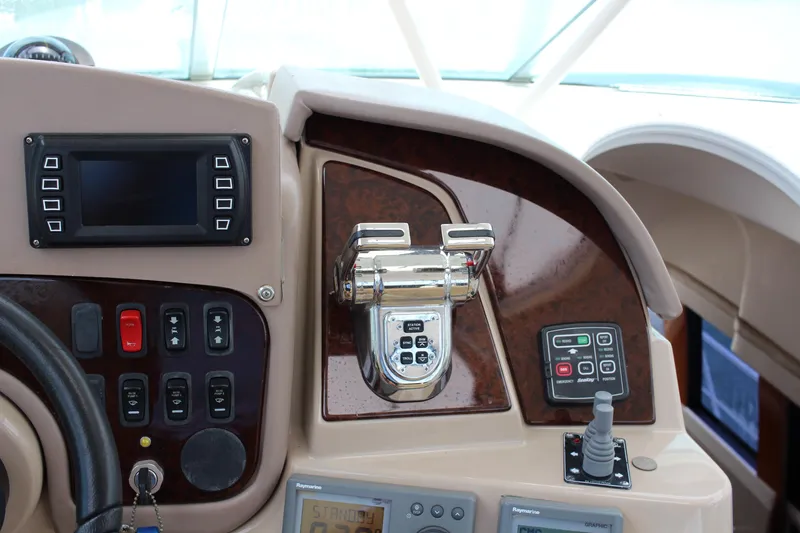 Slide: The Image of Control panel of a 2006 Carver 560 Voyager yacht with navigation and throttle controls. - 31