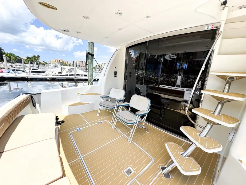 Slide: The Image of 2006 Carver 560 Voyager yacht deck with seating and marina view. - 36