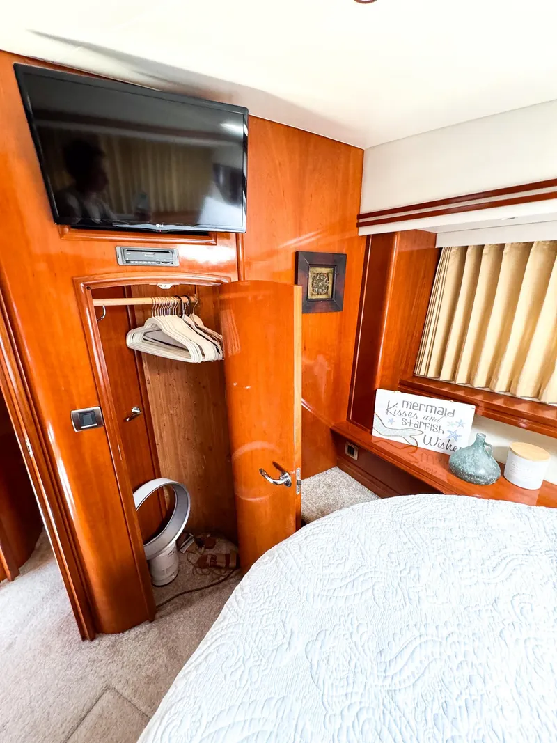 Slide: The Image of Luxurious interior of a 2006 Carver 560 Voyager yacht bedroom with TV and closet. - 38