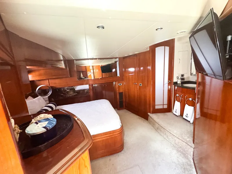 Slide: The Image of Luxurious bedroom interior of a 2006 Carver 560 Voyager yacht with wooden finishes. - 39