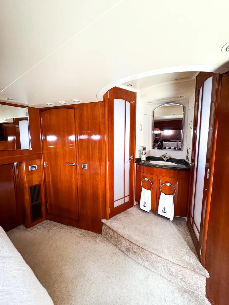 Slide: The Image of Luxurious interior of 2006 Carver 560 Voyager yacht with wooden cabinetry and vanity area. - 40