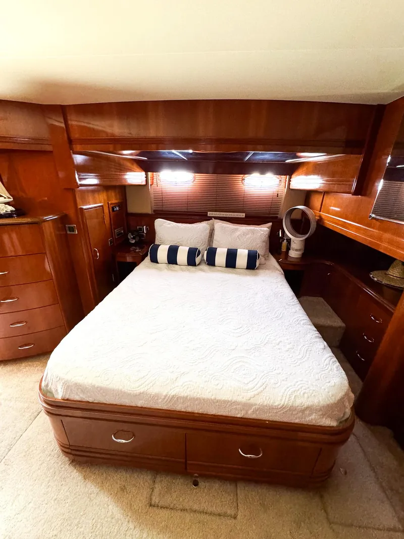 Slide: The Image of Luxurious bedroom interior of 2006 Carver 560 Voyager yacht with wooden cabinetry. - 41