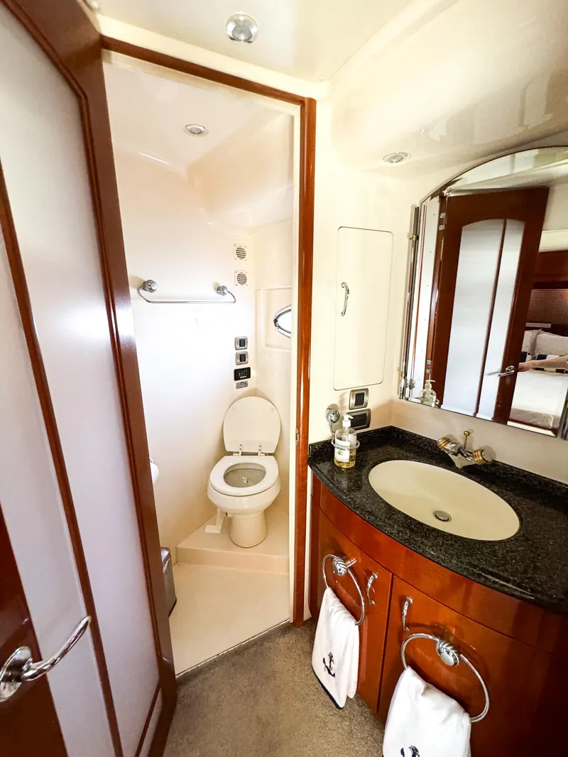 Slide: The Image of 2006 Carver 560 Voyager bathroom with sink, mirror, and toilet. - 42