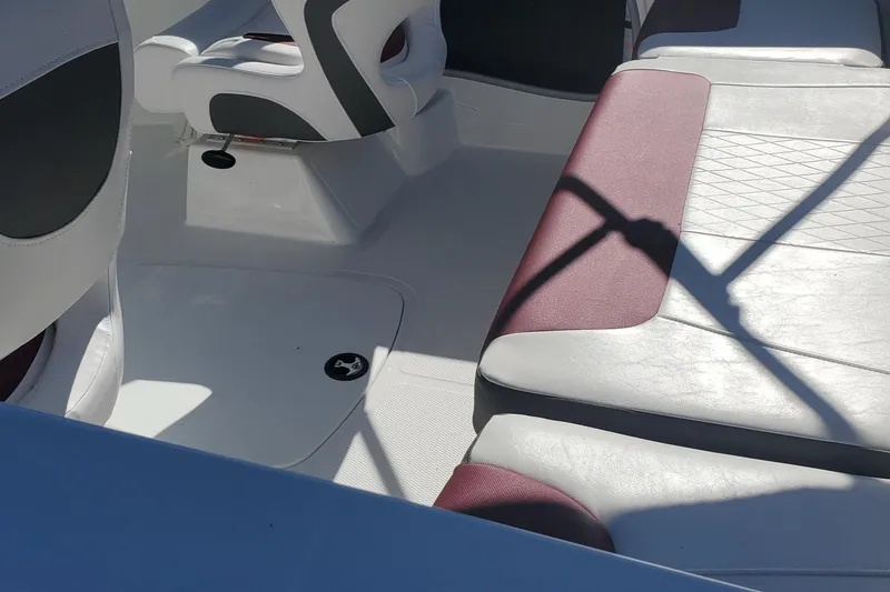 Slide: The Image of 2024 Tahoe 185 S boat interior with white and maroon seating. - 33