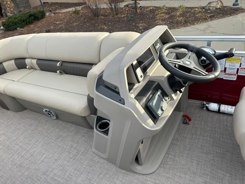 Slide: The Image of 2024 Sun Tracker Party Barge 20 DLX interior with steering console and seating. - 4
