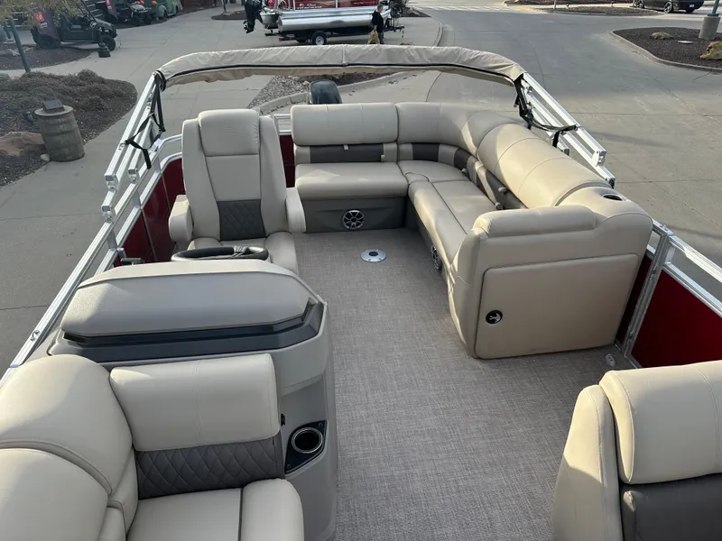 Slide: The Image of 2024 Sun Tracker Party Barge 20 DLX interior with beige seating and spacious layout. - 5