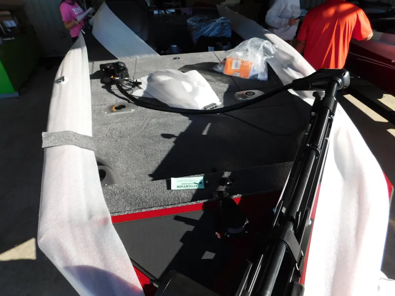 Slide: The Image of 2024 Tracker Pro 170 boat interior with equipment and packaging materials. - 28