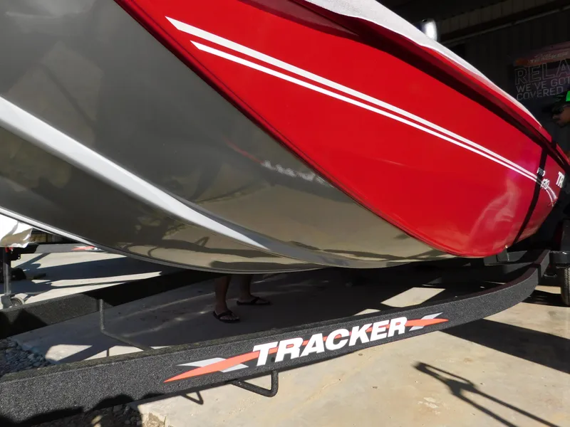 Slide: The Image of 2024 Tracker Pro 170 boat on trailer, featuring sleek red and gray design. - 30