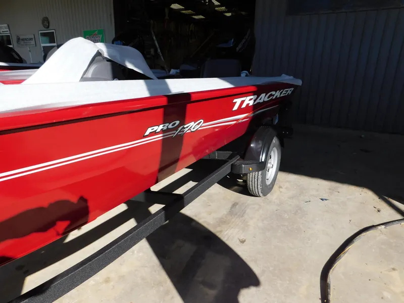 Slide: The Image of 2024 Tracker Pro 170 boat in vibrant red on a trailer, parked outdoors. - 40