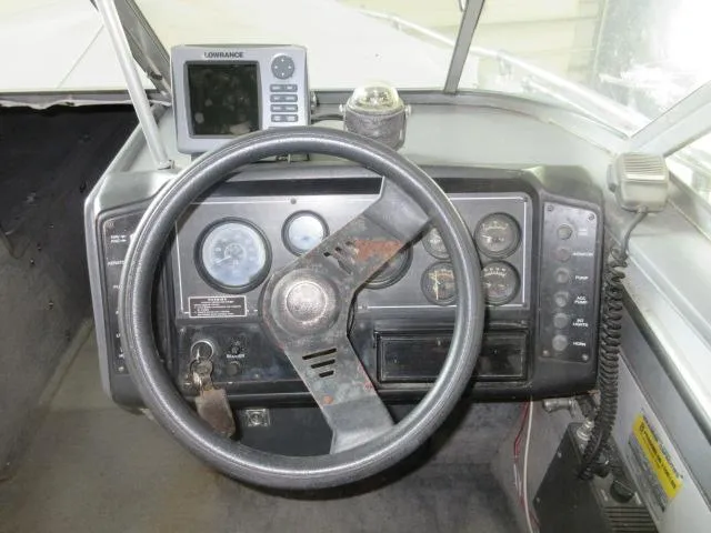 Slide: The Image of Dashboard of a 1990 Lund 1850 Tyee Gran Sport boat with steering wheel and gauges. - 11