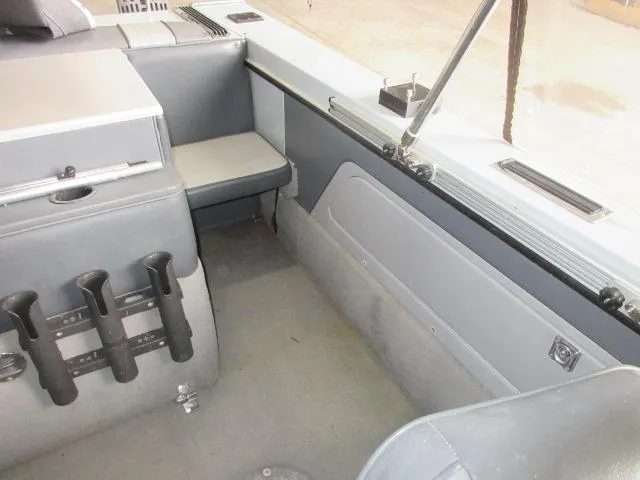 Slide: The Image of Interior of a 1990 Lund 1850 Tyee Gran Sport boat with seating and rod holders. - 19