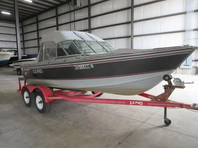Slide: The Image of 1990 Lund 1850 Tyee Gran Sport boat on red trailer in indoor storage. - 3
