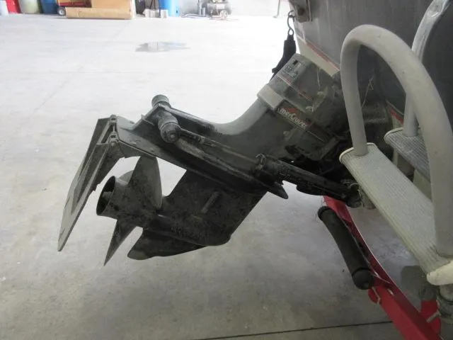 Slide: The Image of Close-up of the outboard motor of a 1990 Lund 1850 Tyee Gran Sport boat. - 7