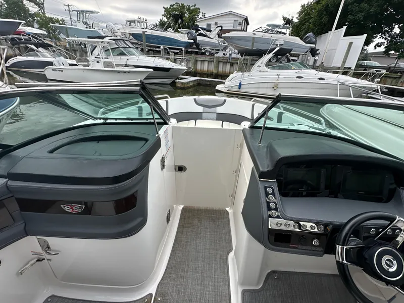 Slide: The Image of 2018 Chaparral 267 SSX boat interior with dashboard and seating area. - 11