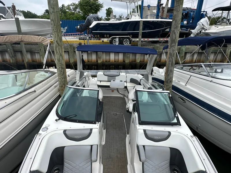Slide: The Image of 2018 Chaparral 267 SSX boat docked among other boats. - 12
