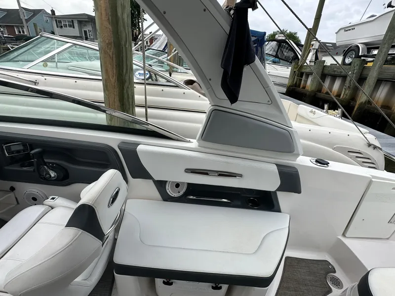 Slide: The Image of Interior of a 2018 Chaparral 267 SSX boat docked at a marina. - 13