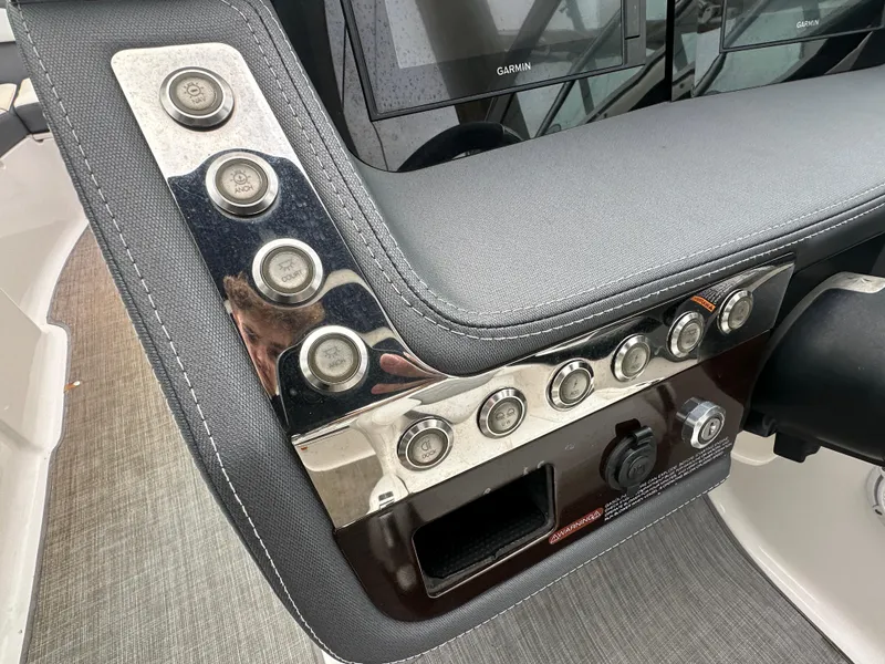 Slide: The Image of Control panel of a 2018 Chaparral 267 SSX boat with buttons and switches. - 4