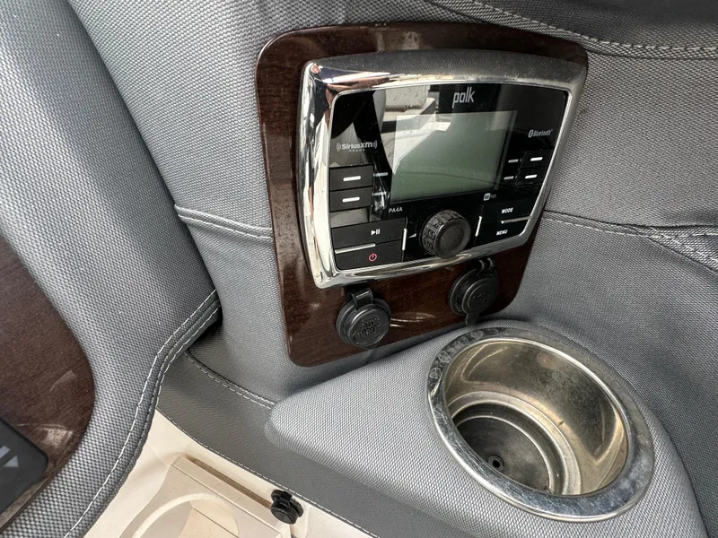 Slide: The Image of 2018 Chaparral 267 SSX boat dashboard with Polk audio system and cup holder. - 5