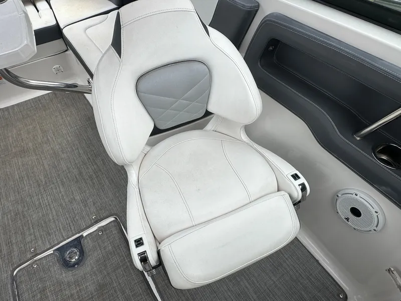 Slide: The Image of 2018 Chaparral 267 SSX boat interior, featuring a white cushioned seat and grey accents. - 9