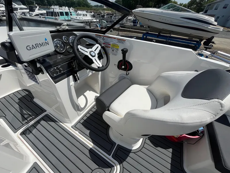Slide: The Image of 2022 Bayliner VR4 Bowrider OB cockpit with Garmin navigation, steering wheel, and comfortable seating. - 5