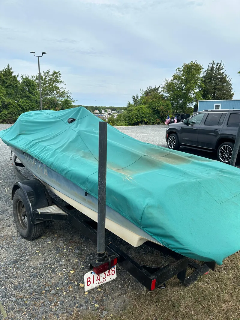 Slide: The Image of Covered 1998 Gekko GTS-20 boat on trailer in parking lot. - 11
