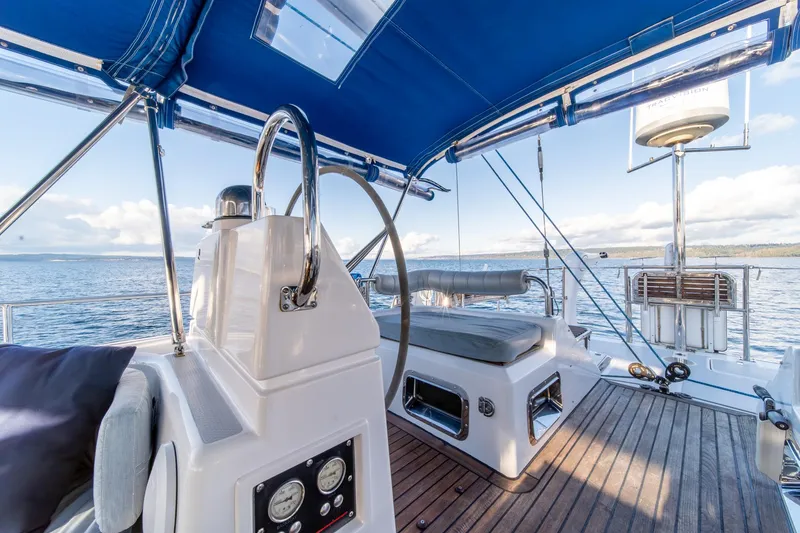 Slide: The Image of Luxurious 2010 Hylas 70 yacht cockpit with blue canopy and ocean view. - 13