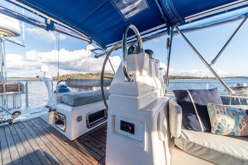 Slide: The Image of Luxurious 2010 Hylas 70 yacht cockpit with blue canopy, steering wheel, and comfortable seating. - 14