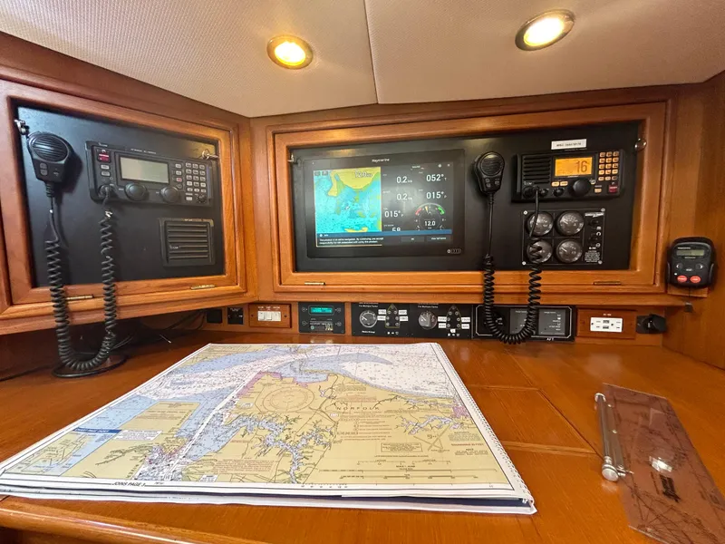 Slide: The Image of Navigation station on a 2010 Hylas 70 yacht with maps and communication equipment. - 20