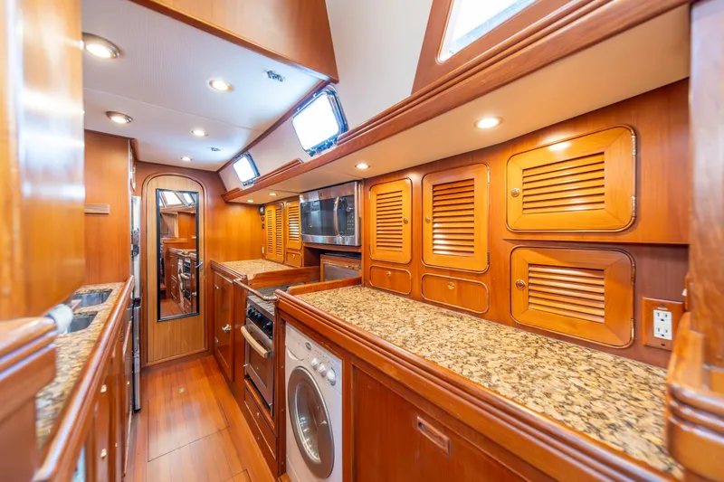 Slide: The Image of Luxurious wooden interior of 2010 Hylas 70 yacht kitchen with granite countertops. - 29