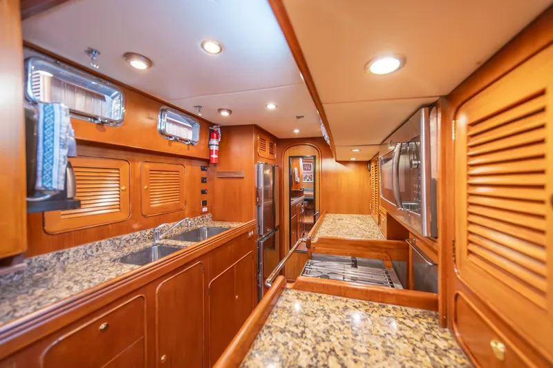 Slide: The Image of Luxurious Hylas 70 yacht kitchen with granite countertops and wooden cabinetry, 2010 model. - 32