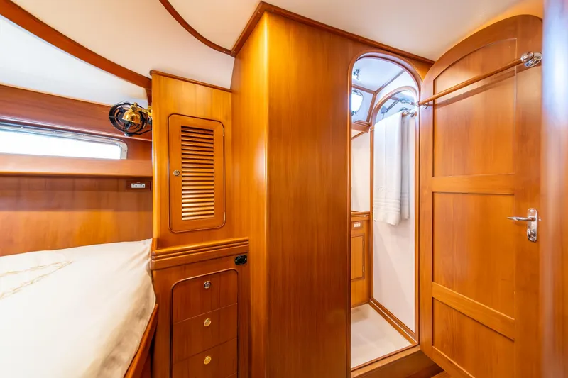 Slide: The Image of Luxurious wooden interior of 2010 Hylas 70 yacht cabin with bed and bathroom. - 42
