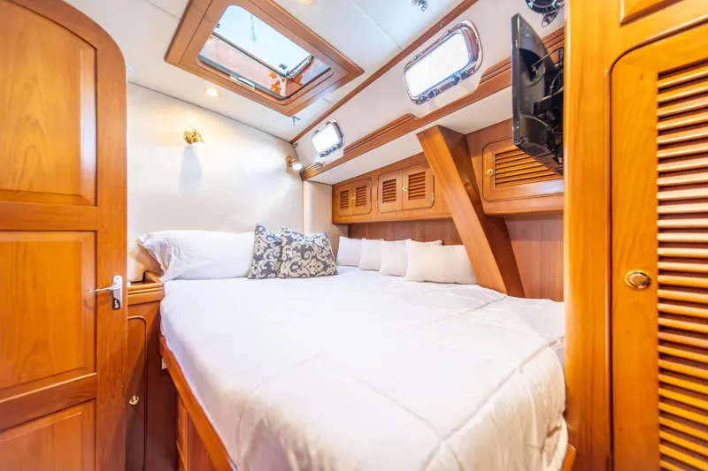 Slide: The Image of Luxurious cabin interior of a 2010 Hylas 70 yacht with wooden finishes. - 48