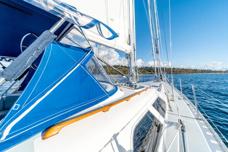 Slide: The Image of Sailing on a 2010 Hylas 70 yacht with blue canopy, clear skies, and calm waters. - 6